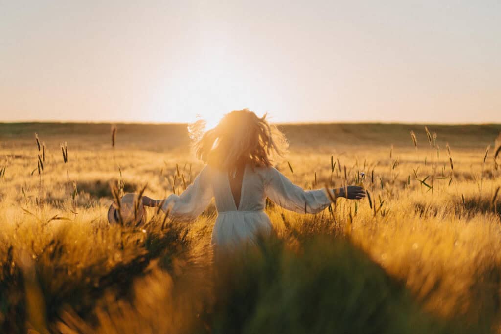 a woman walking in a field symbolizing restful fruitfulness