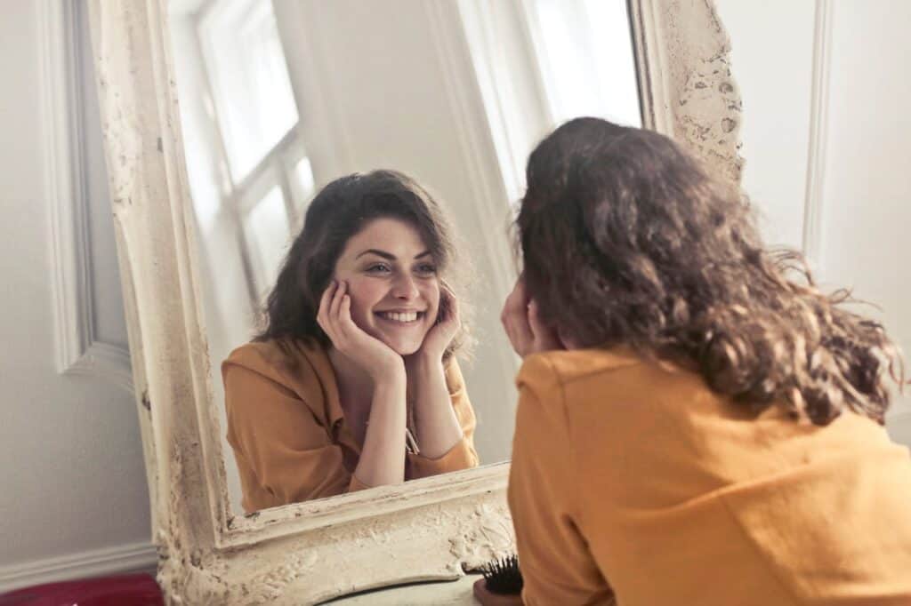 A woman looking into the mirror feeling loved by God